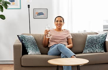 Image showing african american woman with water in glass bottle