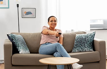 Image showing happy african american woman watching tv at home