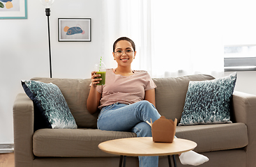 Image showing african american woman drinking smoothie at home