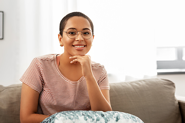 Image showing african american woman in glasses sitting on sofa