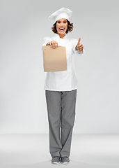 Image showing happy female chef with takeaway food in paper bag