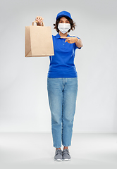 Image showing delivery woman in face mask with food in paper bag