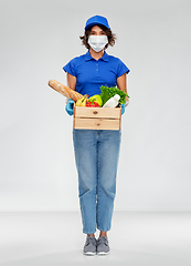 Image showing delivery woman in face mask with food in box