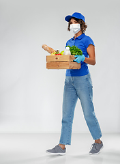 Image showing delivery woman in face mask with food in box