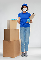 Image showing delivery woman in mask with boxes and clipboard