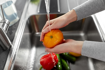 Image showing woman washing fruits and vegetables in kitchen