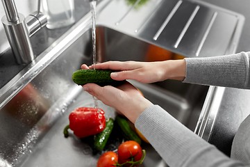 Image showing close up of woman washing vegetables in kitchen