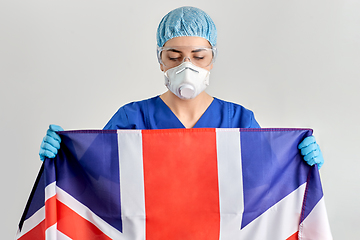 Image showing doctor in goggles and mask holding flag of england