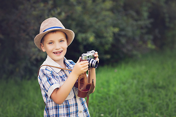 Image showing handsome little boy with retro camera