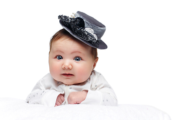 Image showing beautiful baby girl in fancy hat on white blanket