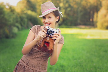 Image showing beautiful teen age girl with retro camera