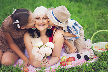 Image showing mother with two kids having picnic outdoors