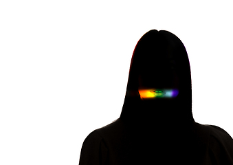 Image showing Dramatic portrait of a girl in the dark on white studio background with rainbow colored line