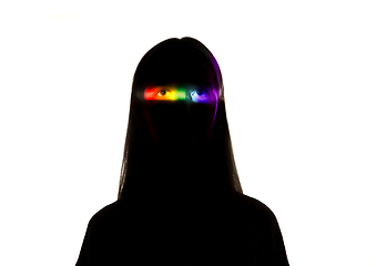 Image showing Dramatic portrait of a girl in the dark on white studio background with rainbow colored line