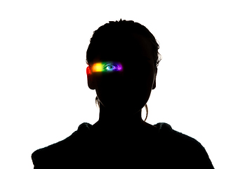 Image showing Dramatic portrait of a girl in the dark on white studio background with rainbow colored line