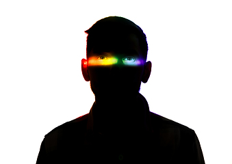 Image showing Dramatic portrait of a man in the dark on white studio background with rainbow colored line