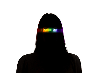 Image showing Dramatic portrait of a girl in the dark on white studio background with rainbow colored line