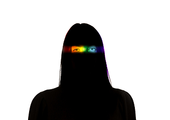 Image showing Dramatic portrait of a girl in the dark on white studio background with rainbow colored line