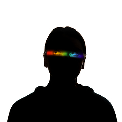 Image showing Dramatic portrait of a girl in the dark on white studio background with rainbow colored line