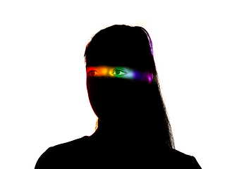 Image showing Dramatic portrait of a girl in the dark on white studio background with rainbow colored line