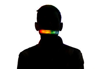 Image showing Dramatic portrait of a man in the dark on white studio background with rainbow colored line
