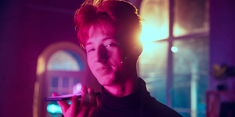 Image showing Cinematic portrait of handsome young man in neon lighted interior