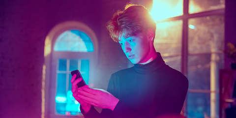 Image showing Cinematic portrait of handsome young man in neon lighted interior