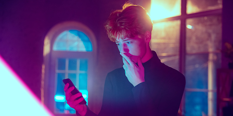 Image showing Cinematic portrait of handsome young man in neon lighted interior