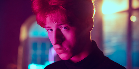 Image showing Cinematic portrait of handsome young man in neon lighted interior