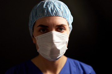 Image showing doctor or nurse in medical face mask and hat