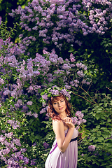 Image showing beautiful girl in purple dress with lilac flowers