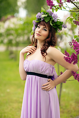 Image showing beautiful girl in purple dress with lilac flowers