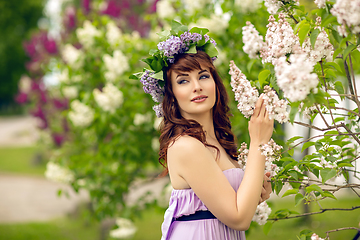 Image showing beautiful girl in purple dress with lilac flowers