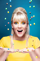 Image showing beautiful blond girl with many colorful candies