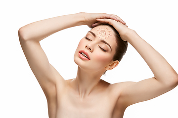 Image showing girl with sun drawing on forehead isolated on white