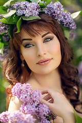 Image showing beautiful girl in purple dress with lilac flowers