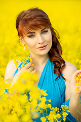 Image showing beautiful girl in blue dress with yellow flowers