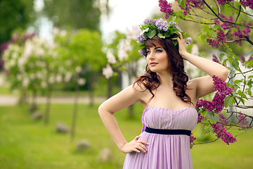 Image showing beautiful girl in purple dress with lilac flowers