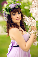 Image showing beautiful girl in purple dress with lilac flowers