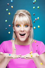 Image showing beautiful blond girl with many colorful candies