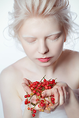 Image showing beautiful albino young woman with red berries