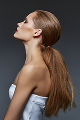 Image showing beautiful girl with long ponytail and red lips