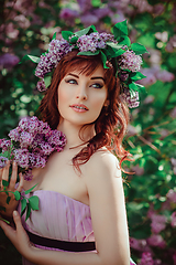 Image showing beautiful girl in purple dress with lilac flowers