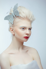 Image showing beautiful albino girl with red lips on white background