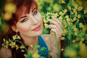 Image showing beautiful girl in blue dress with yellow flowers