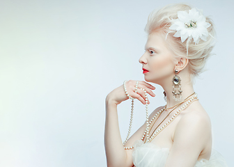 Image showing beautiful albino girl with red lips on white background