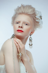 Image showing beautiful albino girl with red lips on white background