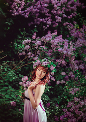 Image showing beautiful girl in purple dress with lilac flowers