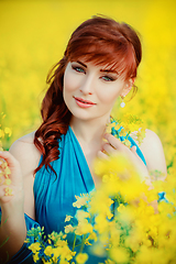 Image showing beautiful girl in blue dress with yellow flowers