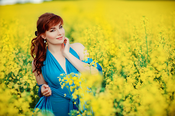 Image showing beautiful girl in blue dress with yellow flowers